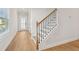 Modern staircase with black metal railing and hardwood floors at 4755 Marjorie Dr, Cumming, GA 30041