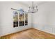 Formal dining room with hardwood floors, wainscoting, and a chandelier at 5065 Winship Ct, Alpharetta, GA 30009