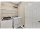 Laundry room with washer, dryer, and shelving at 5065 Winship Ct, Alpharetta, GA 30009