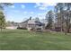 Charming single-story house featuring an expansive backyard with lush lawn and a storage shed at 1250 Olympic Dr, Oxford, GA 30054