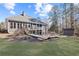 Lovely backyard featuring an expansive wooden deck, shed and lush, green lawn at 1250 Olympic Dr, Oxford, GA 30054