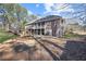 Large backyard with a spacious deck overlooking the lawn and wooded areas at 1250 Olympic Dr, Oxford, GA 30054