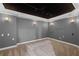 Finished basement media room with gray walls, recessed lighting and plush carpet at 1250 Olympic Dr, Oxford, GA 30054