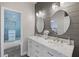 Modern bathroom features double sinks, marble countertops, shiplap accent wall, and shower at 1250 Olympic Dr, Oxford, GA 30054