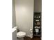 Clean bathroom with a toilet, shelving unit and vanity at 1250 Olympic Dr, Oxford, GA 30054