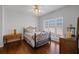 Cozy bedroom features wood floors, natural light, and a stylish wrought iron bed frame at 1250 Olympic Dr, Oxford, GA 30054