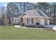 Brick home with a 2-car garage, wooden shutters, manicured landscaping, and a sidewalk leading to the front door at 1250 Olympic Dr, Oxford, GA 30054