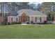 Charming brick home with a well-manicured lawn and decorative wooden accents above the front entrance at 1250 Olympic Dr, Oxford, GA 30054