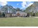 Well-maintained brick home with a manicured lawn and a wood-trimmed gable above the front door at 1250 Olympic Dr, Oxford, GA 30054