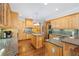Gourmet kitchen with an island, granite countertops, stainless steel appliances, and custom cabinets at 1250 Olympic Dr, Oxford, GA 30054