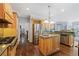 Well-equipped kitchen with an island, stainless steel appliances, granite countertop, and custom cabinets at 1250 Olympic Dr, Oxford, GA 30054