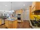 Bright kitchen with an island, custom cabinets, stainless appliances, and an open layout to the breakfast area at 1250 Olympic Dr, Oxford, GA 30054