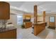 Basement kitchenette featuring wood cabinets, countertops, and a breakfast bar with room for seating at 1250 Olympic Dr, Oxford, GA 30054