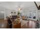 Large living room featuring hardwood floors, a fireplace, large picture windows, and leather couches at 1250 Olympic Dr, Oxford, GA 30054