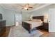 Spacious main bedroom with tray ceiling, wooden furniture, and large rug on hardwood floor at 1250 Olympic Dr, Oxford, GA 30054