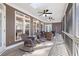 Inviting screened-in porch with comfortable wicker furniture, fans, and view of wooded backyard at 1250 Olympic Dr, Oxford, GA 30054
