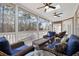 Inviting screened-in porch with comfortable wicker furniture, fans, and view of wooded backyard at 1250 Olympic Dr, Oxford, GA 30054