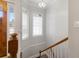 Bright stairwell features wood railing and trim, and natural light from the windows by the front door at 1250 Olympic Dr, Oxford, GA 30054