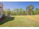Lush green backyard with ample space for recreation and a covered patio for shade at 30 Pinewood Dr, Covington, GA 30014