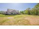Expansive backyard featuring a well-manicured lawn and a covered patio for outdoor enjoyment at 30 Pinewood Dr, Covington, GA 30014