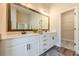 Bathroom featuring double sink vanity with white cabinets and a large mirror at 30 Pinewood Dr, Covington, GA 30014