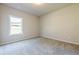Bedroom with neutral walls, carpeted floor, and window overlooking the yard providing lots of natural light at 30 Pinewood Dr, Covington, GA 30014