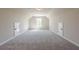 Large bonus room with neutral walls, carpeted floor, and window overlooking the yard providing lots of natural light at 30 Pinewood Dr, Covington, GA 30014