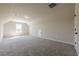 Large bonus room with carpeted floors and high ceilings and natural light from the window at 30 Pinewood Dr, Covington, GA 30014