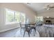 A dining room boasts hardwood floors, neutral wall colors, a brick fireplace, and a view of nature through large windows at 30 Pinewood Dr, Covington, GA 30014