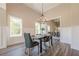A modern dining room features wainscotting, hardwood floors, high ceilings, and a view of nature through large windows at 30 Pinewood Dr, Covington, GA 30014