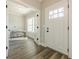 Bright entryway with hardwood floors, leading to a sunlit home office with french doors at 30 Pinewood Dr, Covington, GA 30014