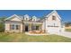 Beautiful two-story home featuring a manicured lawn, white siding and a welcoming two car garage at 30 Pinewood Dr, Covington, GA 30014