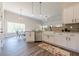 Spacious kitchen featuring white cabinets, stainless steel appliances, granite countertops, and dining area at 30 Pinewood Dr, Covington, GA 30014