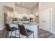 A well-lit kitchen features bar seating, granite countertops, white cabinets, stainless steel appliances, and a butler's pantry at 30 Pinewood Dr, Covington, GA 30014