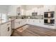 Well-equipped kitchen with stainless steel appliances, white cabinetry, granite countertops, and hardwood floors at 30 Pinewood Dr, Covington, GA 30014