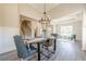 An open-concept living and dining room boasts hardwood floors, wainscotting, a tray ceiling, and neutral wall colors at 30 Pinewood Dr, Covington, GA 30014