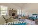 Cozy living room featuring a brick fireplace, comfortable seating, and natural light from large windows at 30 Pinewood Dr, Covington, GA 30014