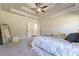 Bright main bedroom featuring neutral walls, carpet, and tray ceiling with fan at 30 Pinewood Dr, Covington, GA 30014