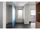 Modern bathroom featuring a glass shower enclosure, white tile, and a window at 199 14Th St # 3003, Atlanta, GA 30309