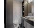 Modern bathroom features a sleek vanity, a toilet, linen tower and light herringbone tile at 199 14Th St # 3003, Atlanta, GA 30309