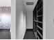 Walk-in closet with custom shelving and dark hardwood flooring at 199 14Th St # 3003, Atlanta, GA 30309