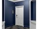 Unit entry door in a freshly painted navy hallway, framed by white trim and with new carpeting at 199 14Th St # 3003, Atlanta, GA 30309