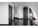 Hallway with black hardwood floors, and multiple doors leading to different rooms in the home at 199 14Th St # 3003, Atlanta, GA 30309