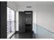 Hallway featuring dark doors, and glass railing overlooking city views at 199 14Th St # 3003, Atlanta, GA 30309