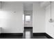 Bright hallway with dark hardwood floors and a window with a city view at 199 14Th St # 3003, Atlanta, GA 30309