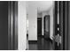 Hallway featuring dark hardwood floors with black doors and trim at 199 14Th St # 3003, Atlanta, GA 30309