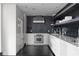 Modern kitchen featuring stainless steel appliances, sleek white cabinetry, and dark hardwood floors at 199 14Th St # 3003, Atlanta, GA 30309