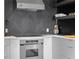 Modern kitchen with stainless steel oven and dark backsplash at 199 14Th St # 3003, Atlanta, GA 30309