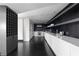 Modern kitchen with sleek cabinetry and a large countertop, accented by dark hardwood floors at 199 14Th St # 3003, Atlanta, GA 30309