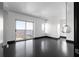Bright, open living room featuring a large balcony, dark hardwood floors, and modern lighting at 199 14Th St # 3003, Atlanta, GA 30309